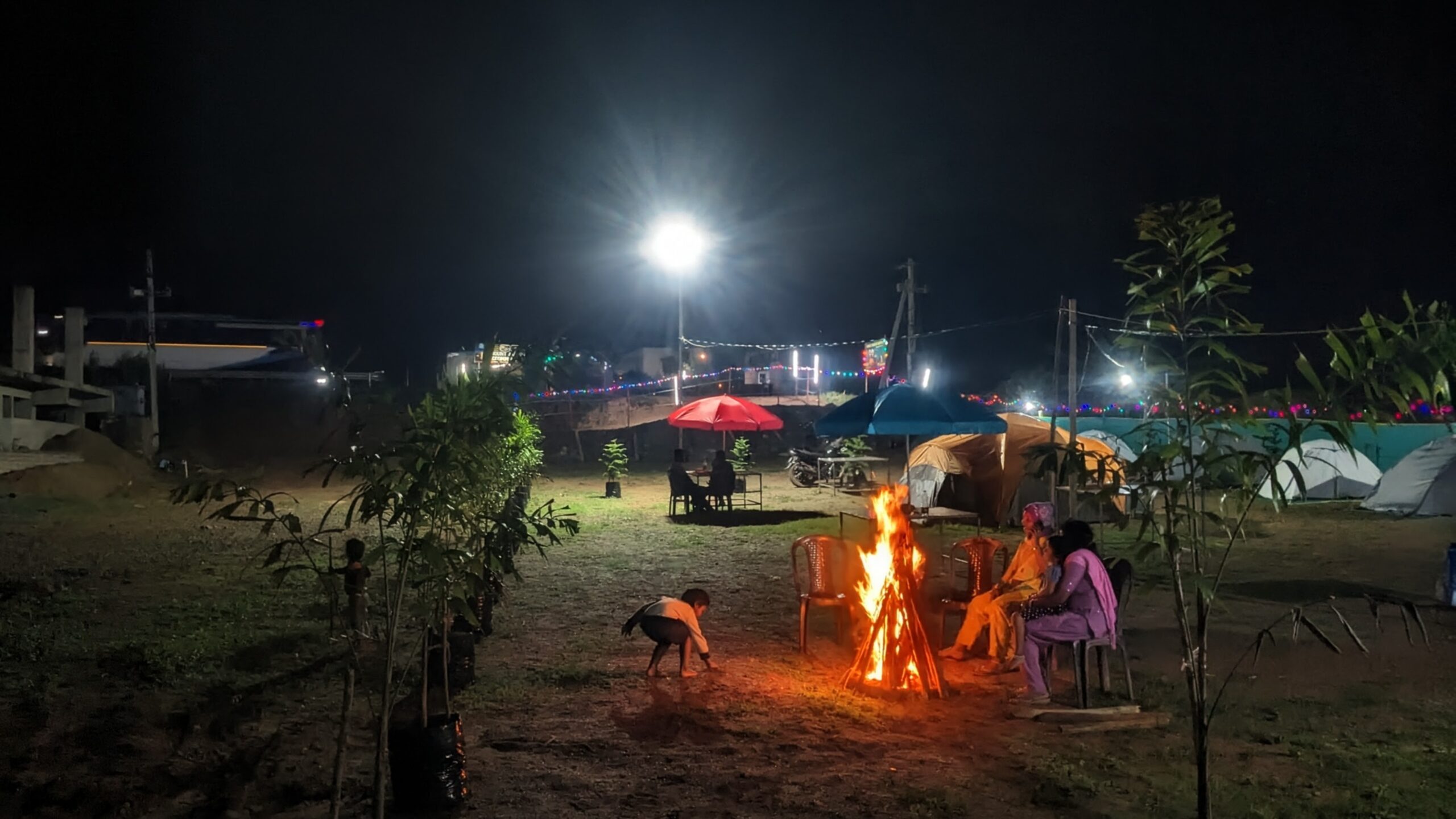 Clean, cozy Araku camping tents setup with warm campfire and outdoor seating—the best places to stay in Araku for atmosphere.